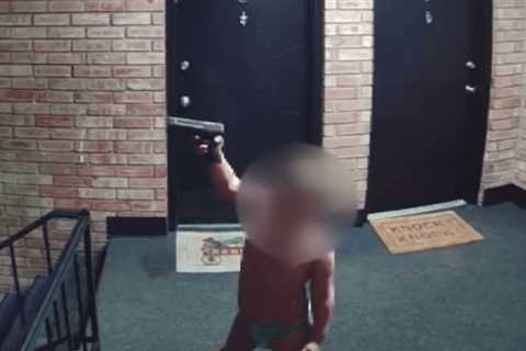 Dad arrested after toddler seen playing with gun on live TV